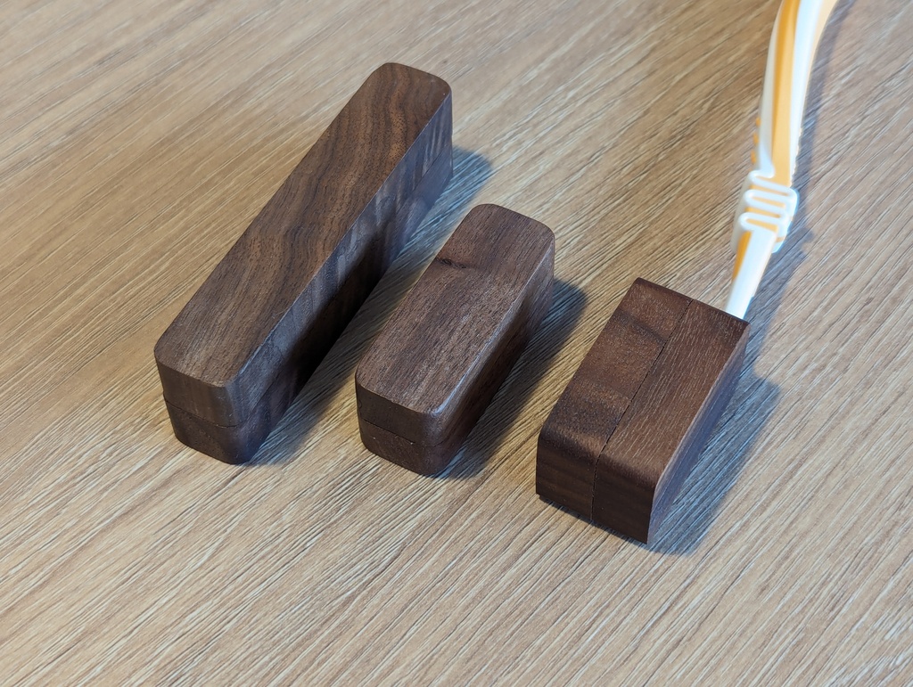 Stylish travel kit, including a toothbrush travel case, razor case, and floss case. Made from real walnut wood, perfect gift for a traveler